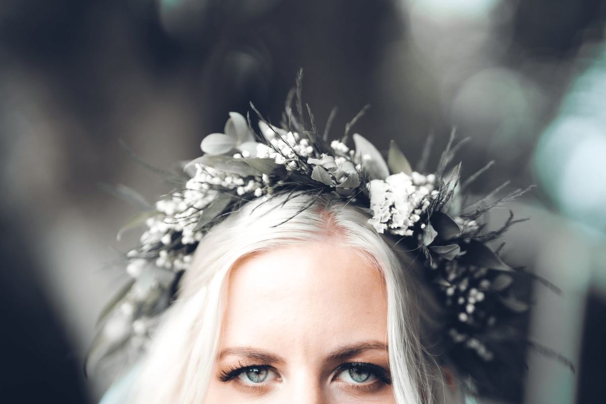 Close-up of a bride in a flower crown with striking eyes