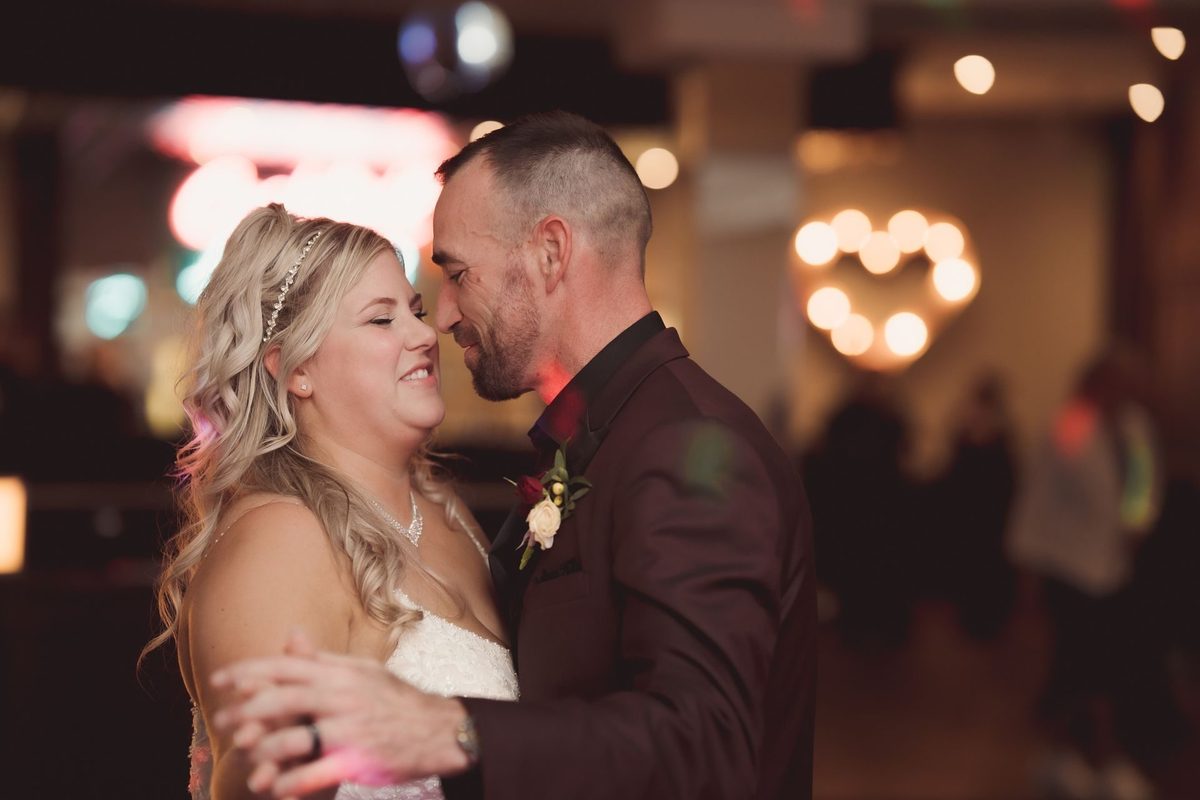 Bride and groom sharing a slow dance at their Retro Suites Hotel reception