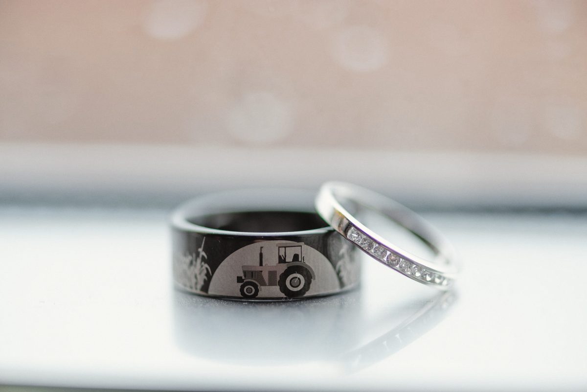 Wedding band and engagement ring standing on a bright white surface