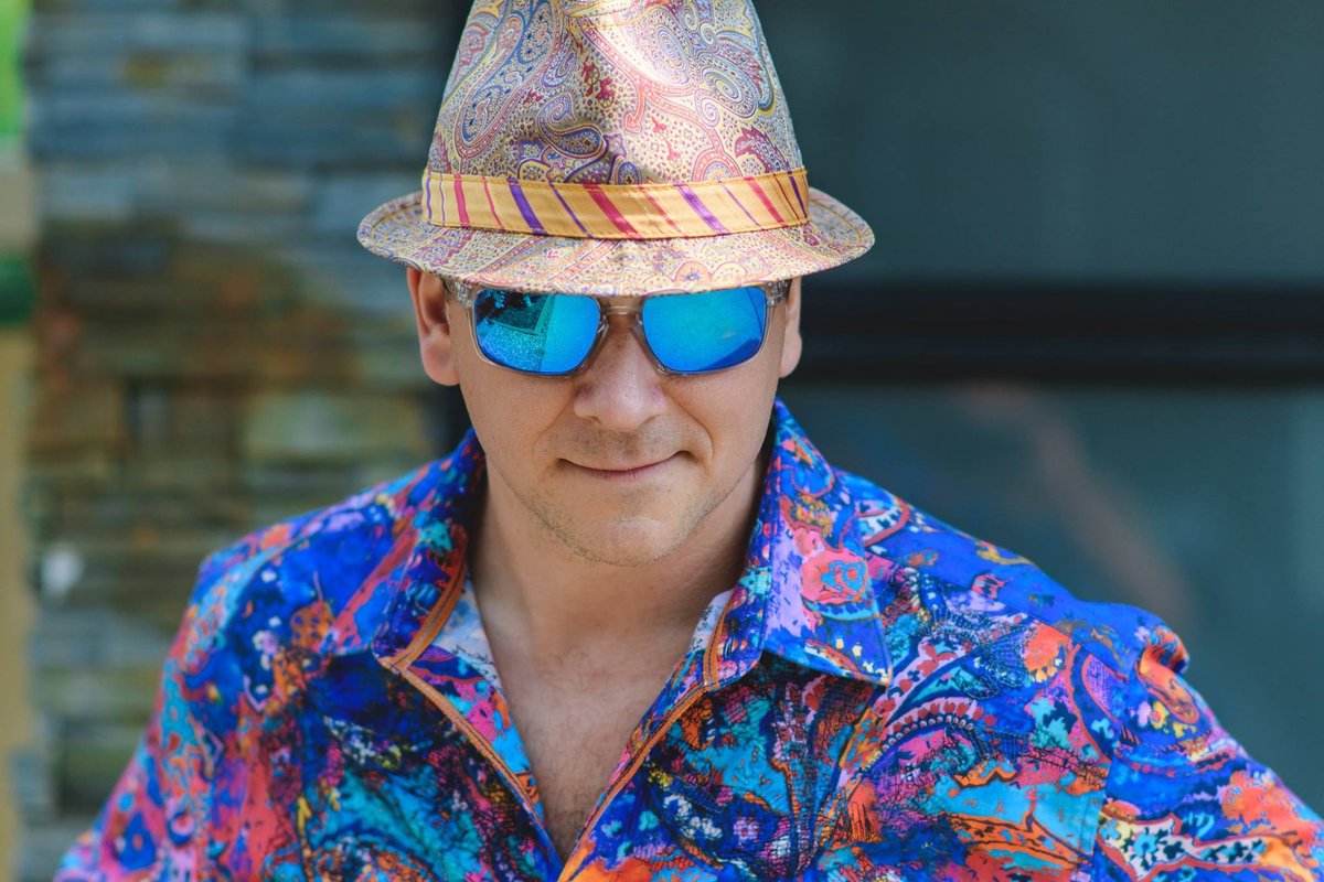Man in a bold print shirt, mirrored sunglasses and hat, a personality-driven brand portrait for Chatham-Kent and Windsor businesses